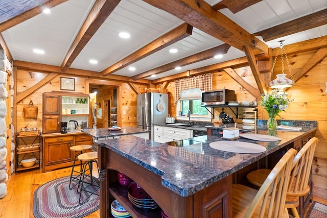 32 Lake Como Dr, Harmony, ME 04942 - kitchen featuring open shelves, light wood-style floors, appliances with stainless steel finishes, wood walls, and a peninsula