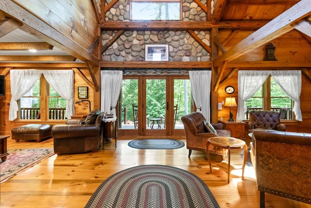 32 Lake Como Dr, Harmony, ME 04942 - living area with wood walls, healthy amount of natural light, high vaulted ceiling, wood-type flooring, and beamed ceiling