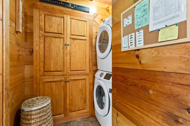 32 Lake Como Dr, Harmony, ME 04942 - laundry area featuring stacked washer / drying machine, cabinet space, and wooden walls