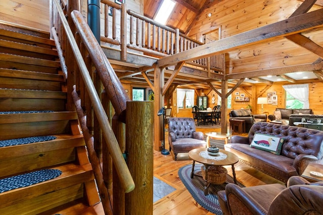 32 Lake Como Dr, Harmony, ME 04942 - living room featuring wood walls, wood-type flooring, stairway, high vaulted ceiling, and a wooden ceiling with exposed beams