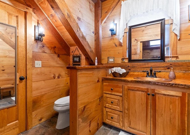 32 Lake Como Dr, Harmony, ME 04942 - bathroom featuring vanity, wood walls, vaulted ceiling, and stone finish floors