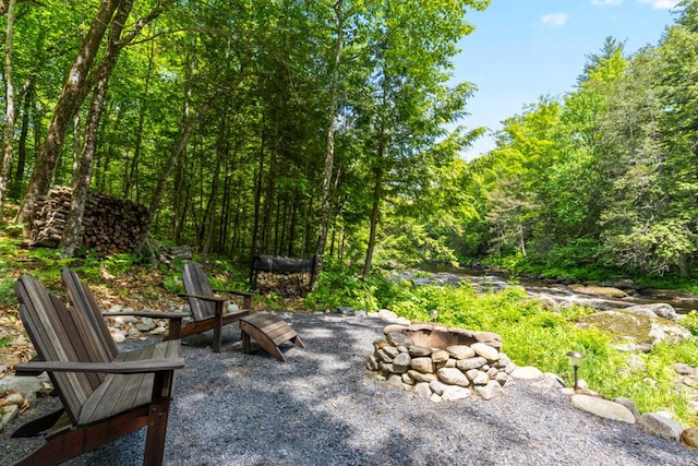 32 Lake Como Dr, Harmony, ME 04942 - view of patio / terrace with an outdoor fire pit and a forest view