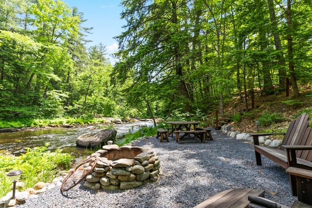 32 Lake Como Dr, Harmony, ME 04942 - view of patio featuring a forest view and outdoor dining area