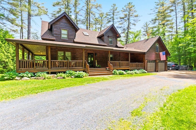 32 Lake Como Dr, Harmony, ME 04942 - log-style house with covered porch, a garage, gravel driveway, and roof with shingles