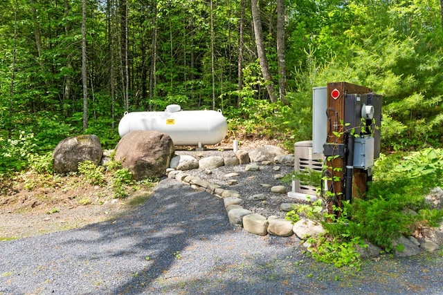 32 Lake Como Dr, Harmony, ME 04942 - exterior view of gas tank and a forest