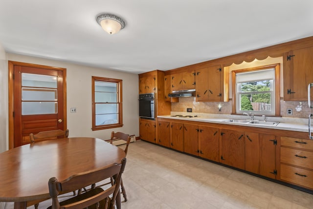 2 Wanda Ln, Gray, ME 04039 - kitchen featuring oven, light countertops, brown cabinetry, and decorative backsplash
