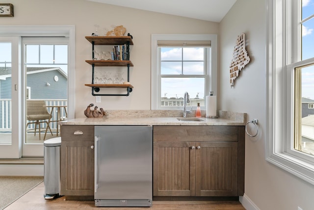 8 Studley Ln, Wells, ME 04090 - indoor wet bar with stainless steel fridge, healthy amount of natural light, light wood finished floors, and lofted ceiling