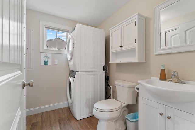 8 Studley Ln, Wells, ME 04090 - bathroom featuring estacked washer and dryer, vanity, and wood finished floors