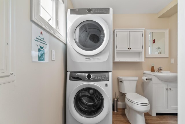8 Studley Ln, Wells, ME 04090 - laundry area featuring stacked washer / drying machine and wood finished floors