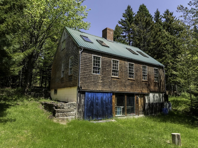 30 Wilkinson Ln, Machiasport, ME 04655 - rear view of house with a chimney, a metal roof, and a standing seam roof