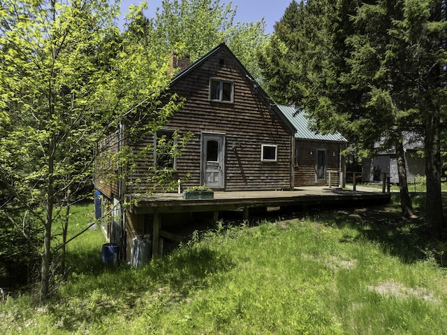 30 Wilkinson Ln, Machiasport, ME 04655 - back of house with a wooden deck, a chimney, and a metal roof