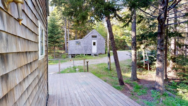 30 Wilkinson Ln, Machiasport, ME 04655 - wooden terrace featuring a shed and view of scattered trees