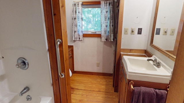 30 Wilkinson Ln, Machiasport, ME 04655 - full bathroom featuring vanity, wood finished floors, and shower / washtub combination