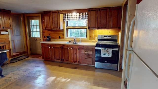 30 Wilkinson Ln, Machiasport, ME 04655 - kitchen with stainless steel gas range, freestanding refrigerator, light countertops, and light wood-style flooring
