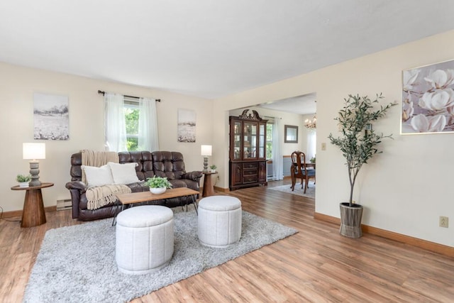 470 Main St, Waterville, ME 04901 - living area with wood finished floors, a chandelier, and baseboard heating