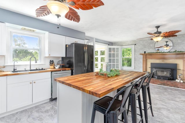 470 Main St, Waterville, ME 04901 - kitchen with wooden counters, freestanding refrigerator, stainless steel dishwasher, and a ceiling fan