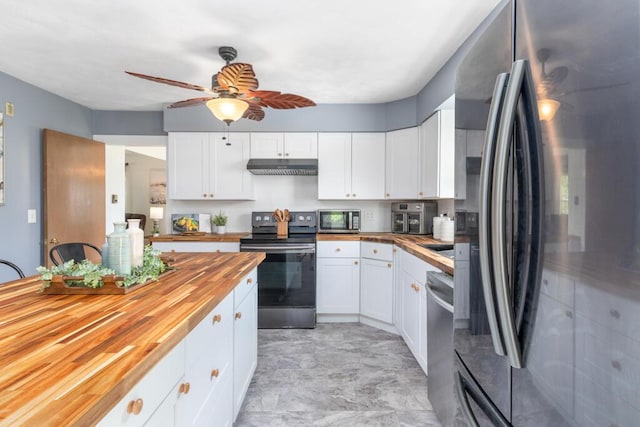 470 Main St, Waterville, ME 04901 - kitchen with appliances with stainless steel finishes, butcher block countertops, under cabinet range hood, ceiling fan, and white cabinets