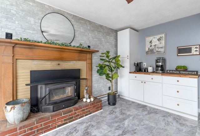 470 Main St, Waterville, ME 04901 - living room featuring brick wall and a wood stove