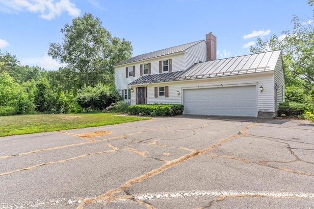 470 Main St, Waterville, ME 04901 - traditional home featuring a standing seam roof, a chimney, a garage, a metal roof, and driveway