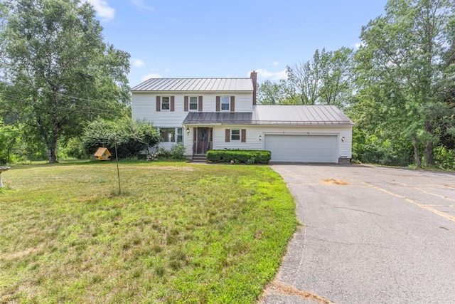 470 Main St, Waterville, ME 04901 - view of front of home with a chimney, asphalt driveway, a garage, a standing seam roof, and a front lawn