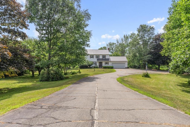 470 Main St, Waterville, ME 04901 - view of front of house featuring driveway, an attached garage, a front yard, and a metal roof