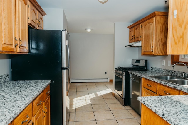 38 Swamp Rd, Bridgton, ME 04009 - kitchen featuring stainless steel appliances, a baseboard radiator, under cabinet range hood, and brown cabinetry