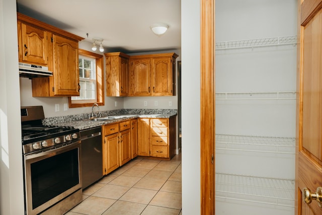 38 Swamp Rd, Bridgton, ME 04009 - kitchen featuring stainless steel gas range oven, range hood, dishwasher, light tile patterned floors, and brown cabinetry