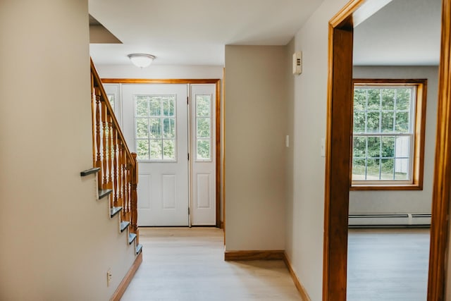 38 Swamp Rd, Bridgton, ME 04009 - doorway to outside with a baseboard radiator, light wood-style floors, and stairway