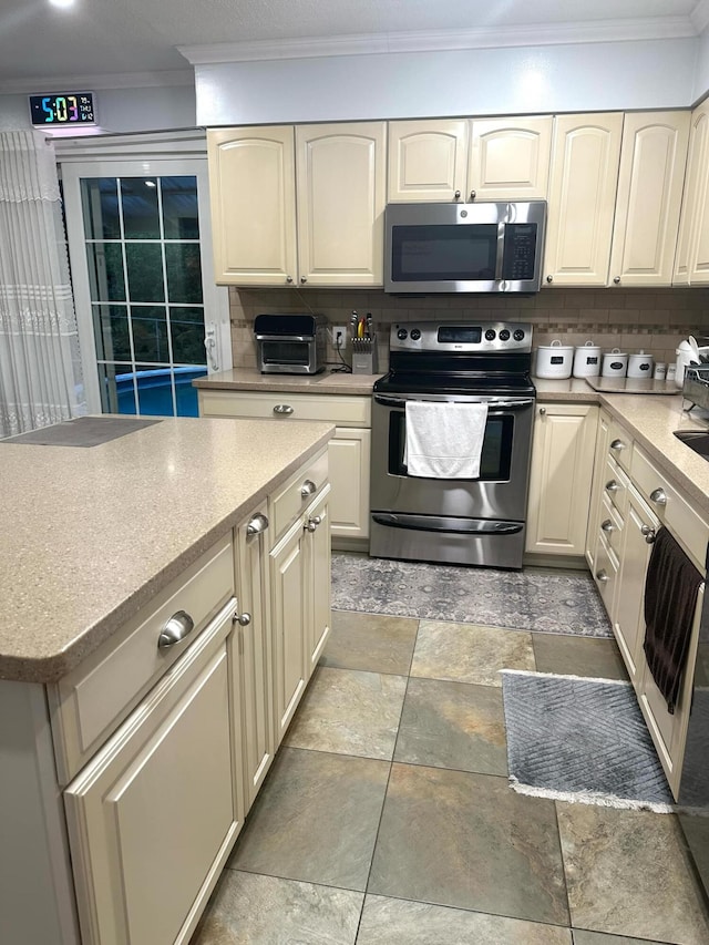 7 Lorraine Ave, Lewiston, ME 04240 - kitchen featuring stainless steel appliances, ornamental molding, decorative backsplash, light countertops, and light stone finish floors