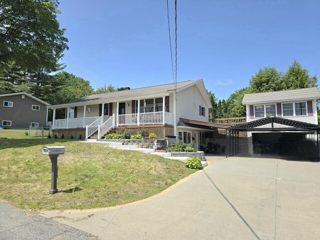 7 Lorraine Ave, Lewiston, ME 04240 - view of front of home featuring a porch, a front yard, concrete driveway, and a garage