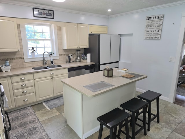 7 Lorraine Ave, Lewiston, ME 04240 - kitchen with freestanding refrigerator, dishwasher, decorative backsplash, a kitchen breakfast bar, and light countertops