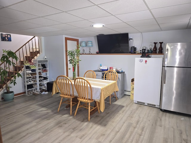7 Lorraine Ave, Lewiston, ME 04240 - dining room with wood finished floors, a drop ceiling, stairs, and a baseboard radiator