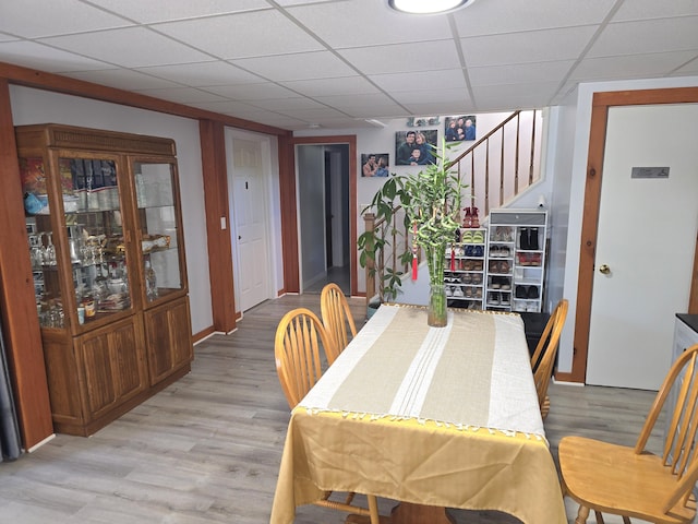 7 Lorraine Ave, Lewiston, ME 04240 - dining space featuring stairway, light wood-style flooring, and a paneled ceiling