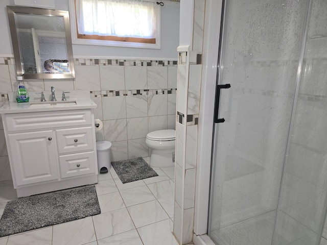 7 Lorraine Ave, Lewiston, ME 04240 - bathroom with tile walls, vanity, a shower stall, and tile patterned flooring