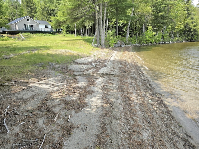502 Cedar Lake Rd, Millinocket, ME 04462 - view of yard with a wooded view, dirt driveway, and a deck with water view