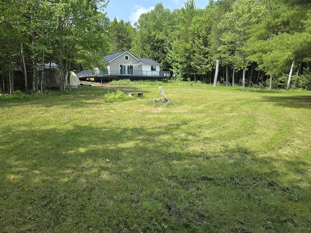 502 Cedar Lake Rd, Millinocket, ME 04462 - view of grassy yard featuring a wooden deck and a forest view
