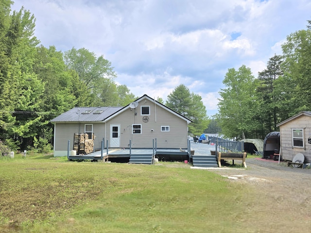 502 Cedar Lake Rd, Millinocket, ME 04462 - rear view of property featuring a yard, a wooden deck, and a metal roof