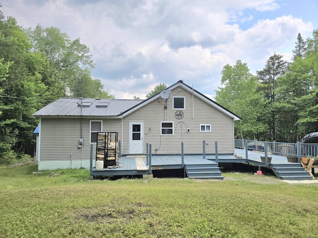 502 Cedar Lake Rd, Millinocket, ME 04462 - back of property featuring a lawn, a wooden deck, and a metal roof