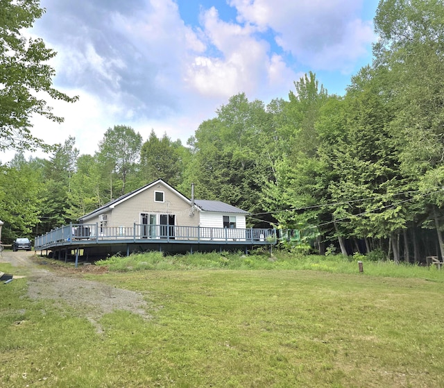 502 Cedar Lake Rd, Millinocket, ME 04462 - view of home's exterior featuring a deck and a lawn