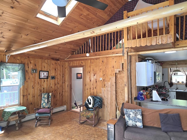 502 Cedar Lake Rd, Millinocket, ME 04462 - living area with a skylight, a baseboard radiator, wood walls, and high vaulted ceiling