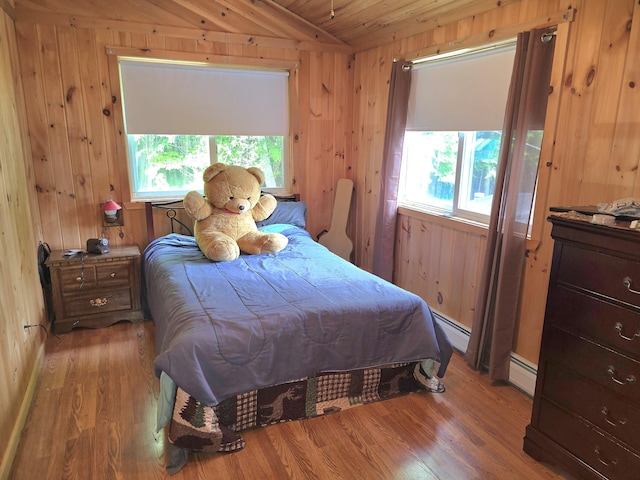 502 Cedar Lake Rd, Millinocket, ME 04462 - bedroom with vaulted ceiling, wood finished floors, wood walls, a baseboard heating unit, and wooden ceiling