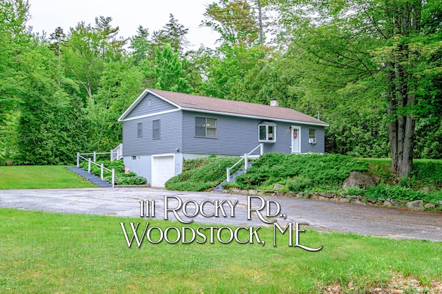 111 Rocky Rd, Woodstock, ME 04219 - single story home featuring an attached garage, driveway, a front lawn, stairway, and a chimney