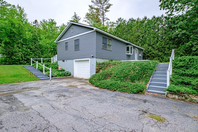 111 Rocky Rd, Woodstock, ME 04219 - view of side of property with stairway, an attached garage, and driveway
