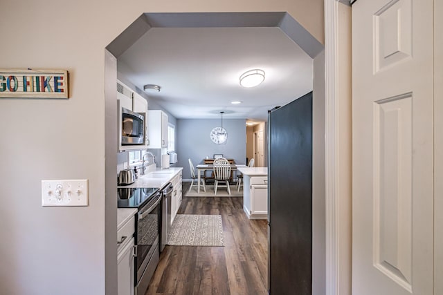 111 Rocky Rd, Woodstock, ME 04219 - kitchen featuring stainless steel appliances, light countertops, white cabinets, and dark wood-style flooring