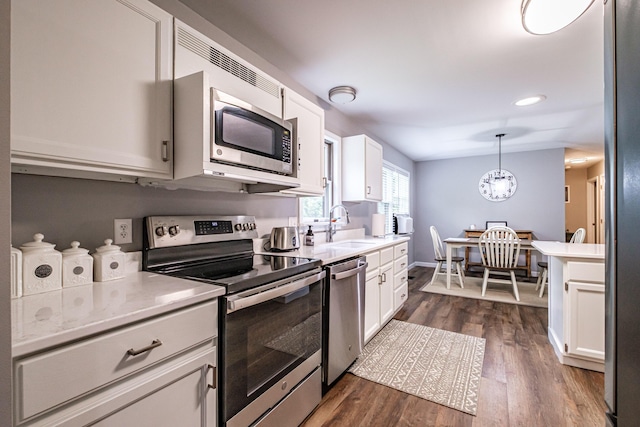 111 Rocky Rd, Woodstock, ME 04219 - kitchen with stainless steel appliances, light countertops, white cabinets, and recessed lighting