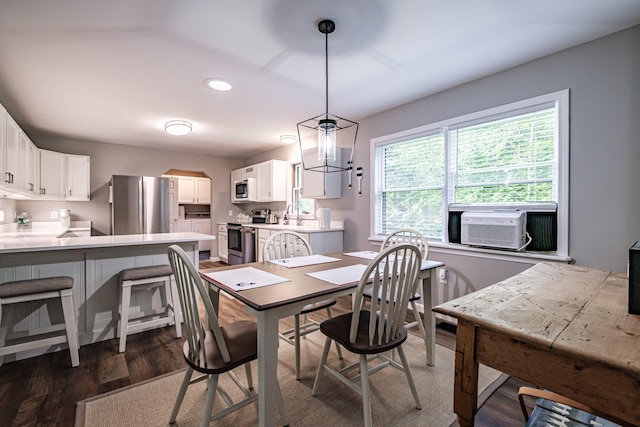 111 Rocky Rd, Woodstock, ME 04219 - dining space with dark wood finished floors, recessed lighting, arched walkways, and cooling unit
