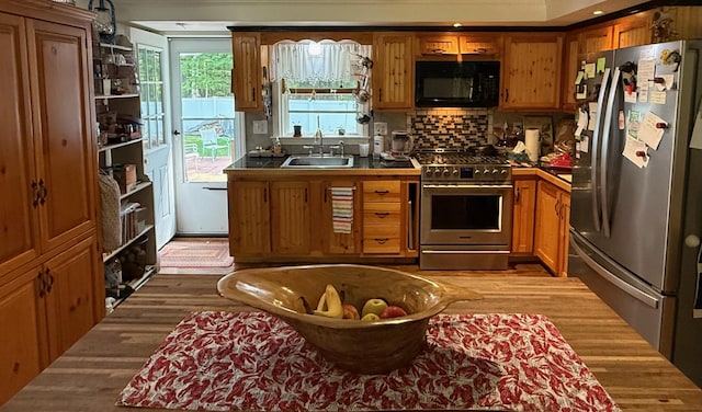 49 31st St, Shapleigh, ME 04076 - kitchen with stainless steel appliances, brown cabinets, dark wood-style floors, and tasteful backsplash