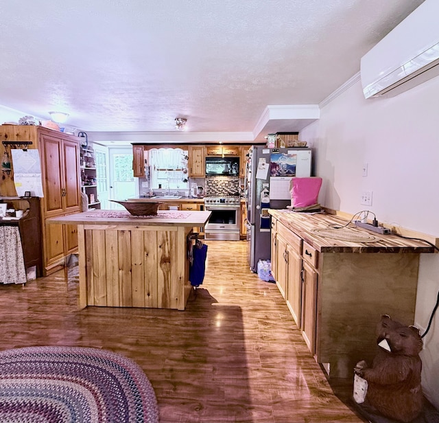 49 31st St, Shapleigh, ME 04076 - kitchen with appliances with stainless steel finishes, a wall mounted air conditioner, light wood-type flooring, a center island, and open shelves