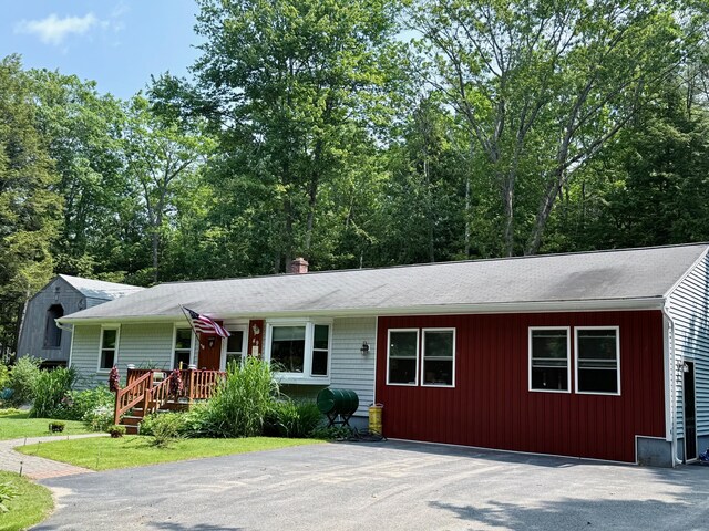 49 31st St, Shapleigh, ME 04076 - ranch-style house with driveway, roof with shingles, and a chimney