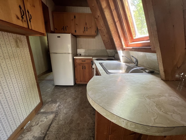 20 Lemeuls Rd, Bristol, ME 04558 - kitchen featuring freestanding refrigerator, wallpapered walls, light countertops, and brown cabinets